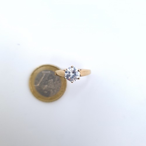 675 - A very pretty  cubic zirconia solitaire ring set in gold, In 9K gold band, size O, weight 2.48 grams... 