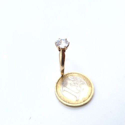 675 - A very pretty  cubic zirconia solitaire ring set in gold, In 9K gold band, size O, weight 2.48 grams... 