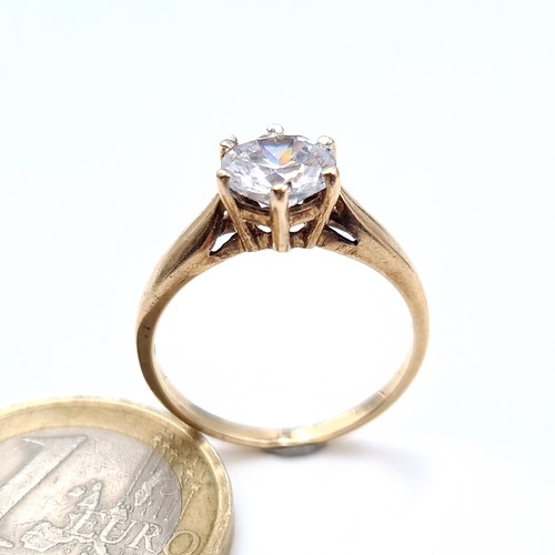 675 - A very pretty  cubic zirconia solitaire ring set in gold, In 9K gold band, size O, weight 2.48 grams... 