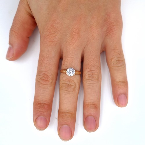 675 - A very pretty  cubic zirconia solitaire ring set in gold, In 9K gold band, size O, weight 2.48 grams... 