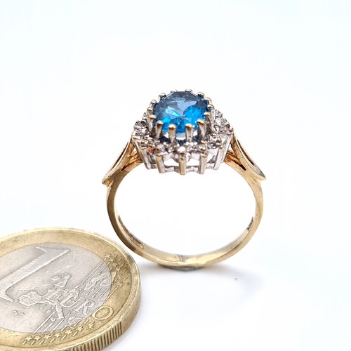 676 - Star Lot : A beautiful blue topaz ring with diamond cluster surround, mounted in 9K gold (375), ring... 