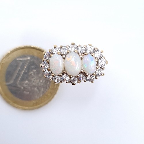 684 - Star Lot An unusual heavy, three stone opal ring with gem set surround mounted in 9K gold, ring size... 