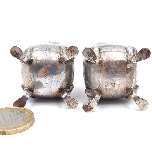 696 - Two sterling silver pepperettes standing on four paw feet, hallmarked Birmingham, height 8cm, set wi... 