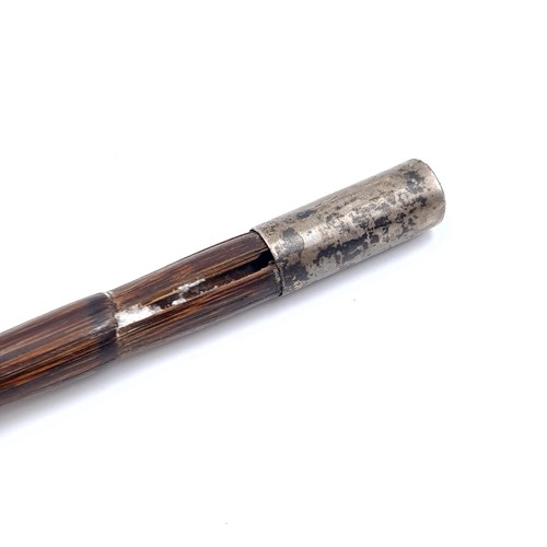 700 - The top of a cane finished with silver ferrule with a gilt mount finished with a polished gem fittin... 