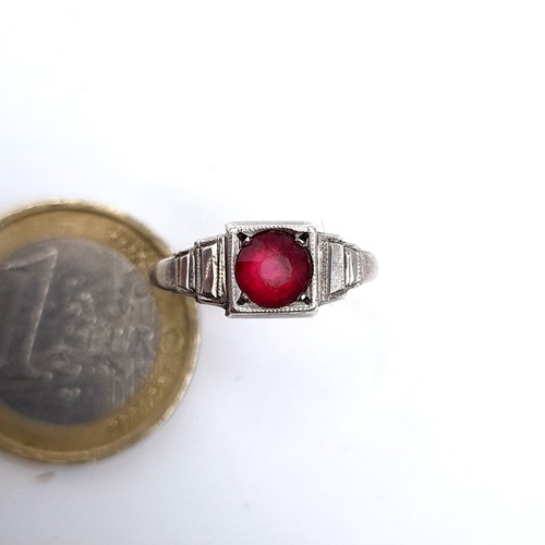 711 - Star Lot : A 9K white gold diamond and ruby stone ring, size M, weight 2.57 grams, boxed.