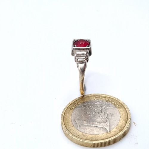 711 - Star Lot : A 9K white gold diamond and ruby stone ring, size M, weight 2.57 grams, boxed.