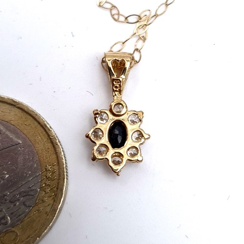 720 - A sapphire flower pendant, hallmarked 9K gold to mount and chain, set with gemstone surround, length... 