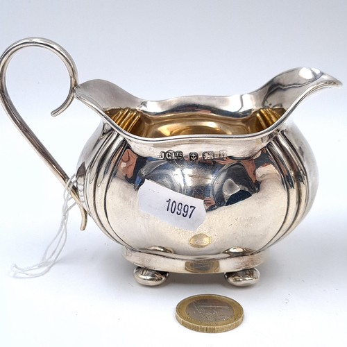 727 - Star Lot : A sterling silver sugar together with a matching cream jug hallmarked Birmingham, maker J... 