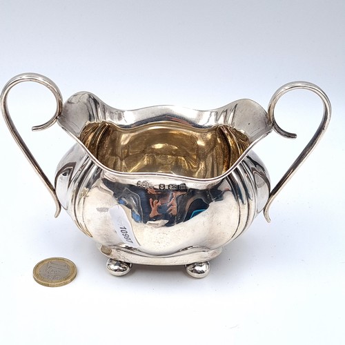 727 - Star Lot : A sterling silver sugar together with a matching cream jug hallmarked Birmingham, maker J... 