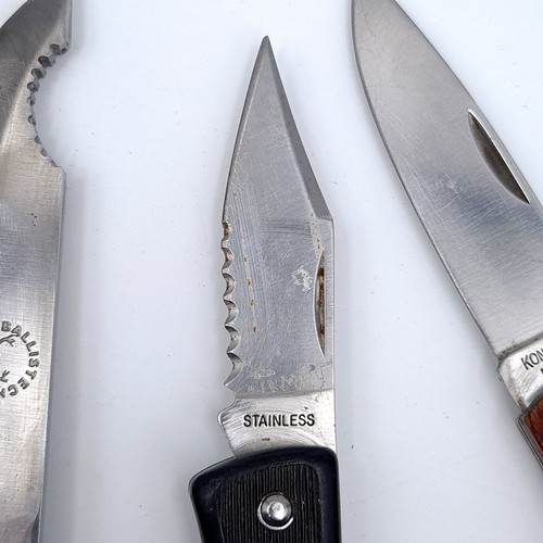 734 - A collection of five knives including a cut throat barbers example and a Ballistech hunting knife to... 