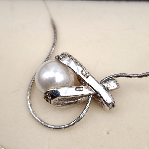 746 - A sterling silver pearl mounted pendant with chain, length 42cm, boxed.