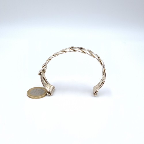 752 - A twist link torc bracelet , weight 37 grams.