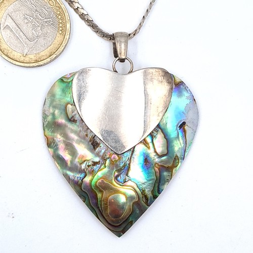 754 - A very pretty sterling silver heart shaped pendant with abalone shell detail together with chain, le... 