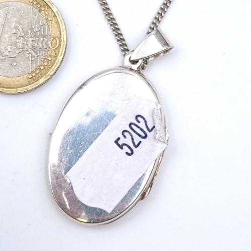 759 - A sterling silver pendant locket with chain. length of 40cm, total weight 12 grams.