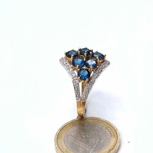 763 - Star Lot : A super quality 9K gold nine stone topaz and diamond brilliant cut ring, hallmarked Birmi... 