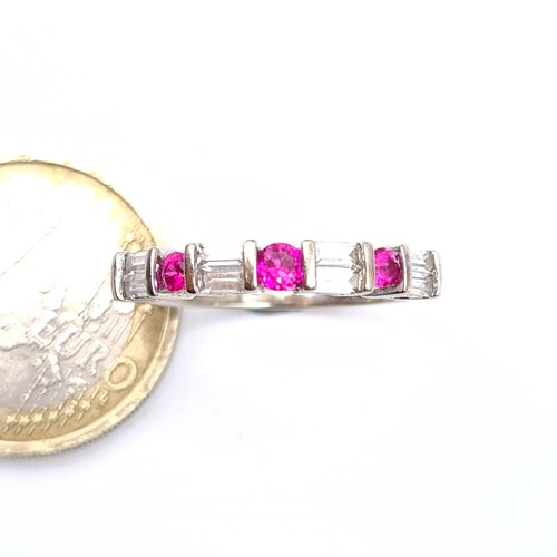 778 - Star Lot : A fine example of a ruby and diamond half eternity ring, set in 10K white gold, size P, w... 