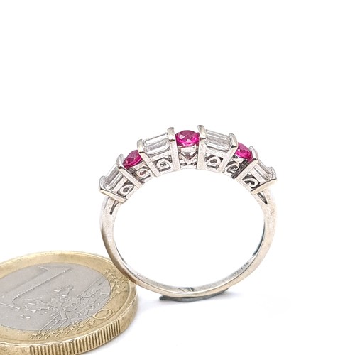 778 - Star Lot : A fine example of a ruby and diamond half eternity ring, set in 10K white gold, size P, w... 