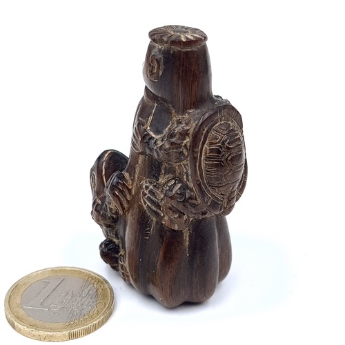 779 - A vintage carved netsuki figure of a standing monkey with a tortoise and toad with marks to base,5.5... 