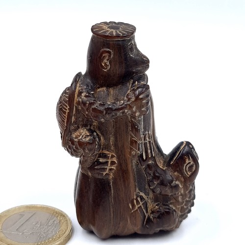 779 - A vintage carved netsuki figure of a standing monkey with a tortoise and toad with marks to base,5.5... 