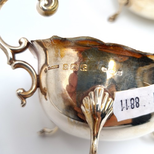 781 - Star Lot : A pair of matching sterling silver sauce boats with flying 