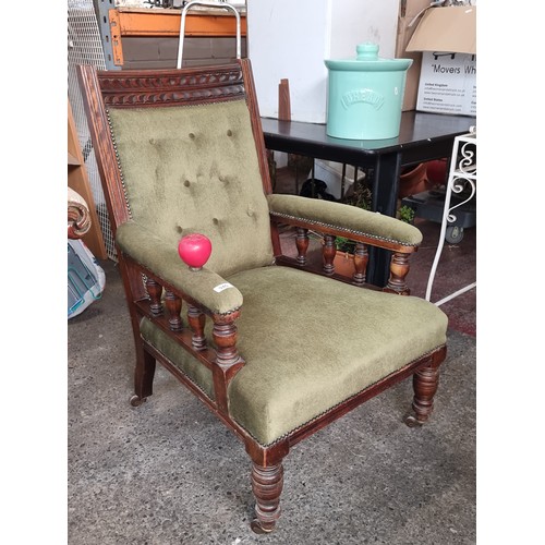 940 - A very elegant Victorian armchair with profusely turned supports and carved backrest. Features butto... 