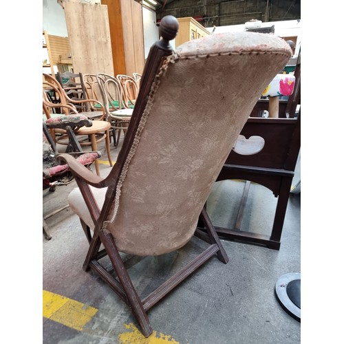 423 - An antique Edwardian high back wooden frame arm chair. Frame is solid and seat still well sprung but... 