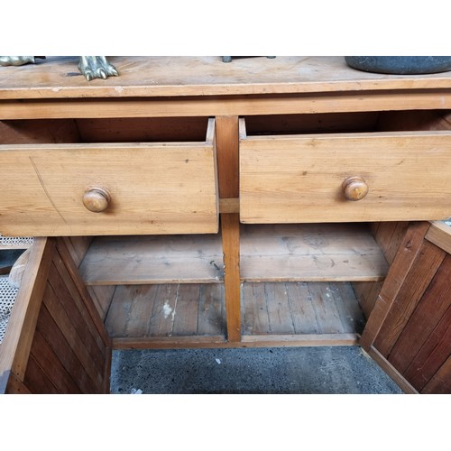 469 - Star Lot : An antique  pine buffet cabinet / sideboard with two deep top drawers and large cupboard ... 