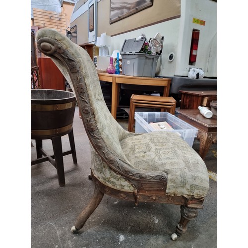 459 - A beautiful mid Victorian slipper chair with scrolled back and floral carving throughout wooden fram... 