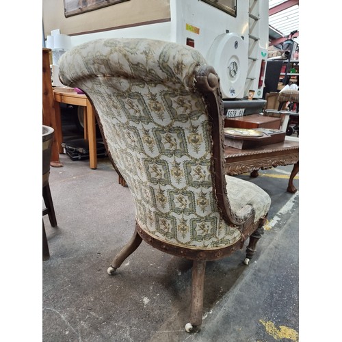 459 - A beautiful mid Victorian slipper chair with scrolled back and floral carving throughout wooden fram... 