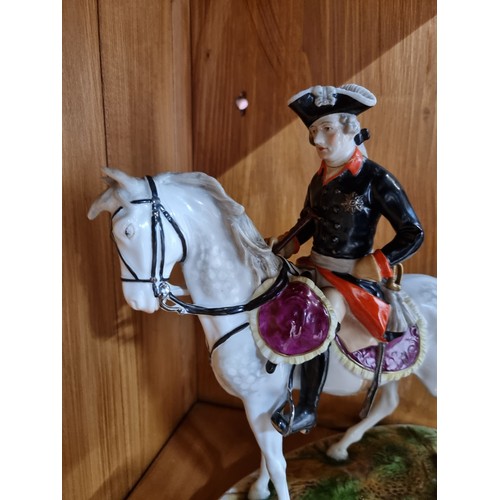 831 - A fabulous large German porcelain figure of a solider on horseback.