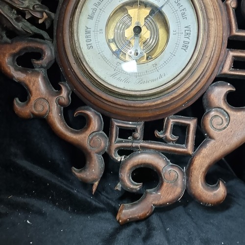 666 - Star Lot A fabulous early 20th century carved wooden French metallic barometer with a highly unusual... 