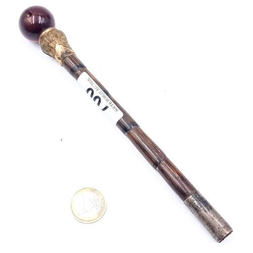 700 - The top of a cane finished with silver ferrule with a gilt mount finished with a polished gem fittin... 