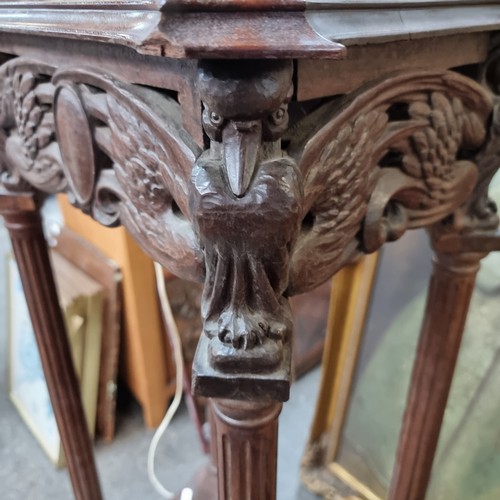 919 - A very ornate early 20th century plant stand with profusely carved detailing, shelf to base and ball... 