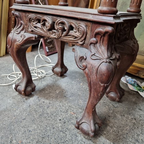 919 - A very ornate early 20th century plant stand with profusely carved detailing, shelf to base and ball... 