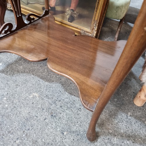 928 - Star lot : A handsome Edwardian window table boasting profuse scroll edges, shelf to base and cabrio... 