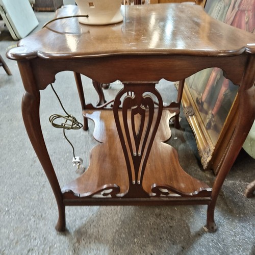 928 - Star lot : A handsome Edwardian window table boasting profuse scroll edges, shelf to base and cabrio... 