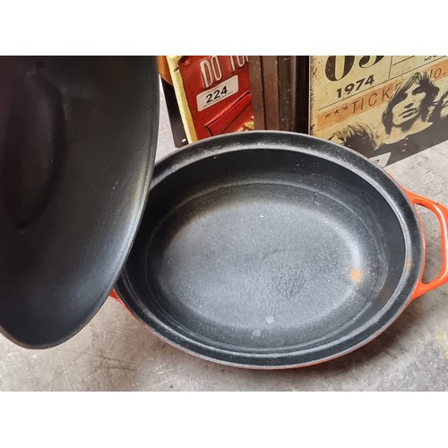 202 - A vintage very heavy cast iron Colorcast Waterford Ireland dutch oven with lid and handles in an ora... 