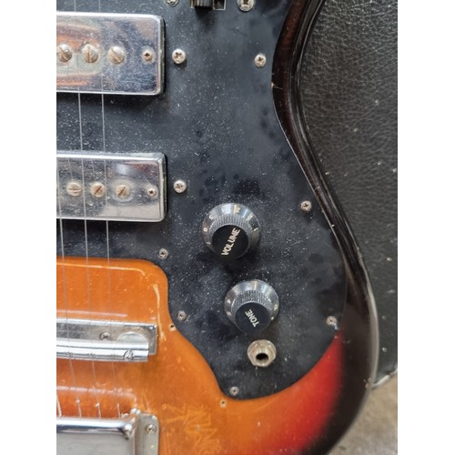 268 - Star lot: A rare vintage Harmony electric guitar with all strings, a black and brown finish and blac... 