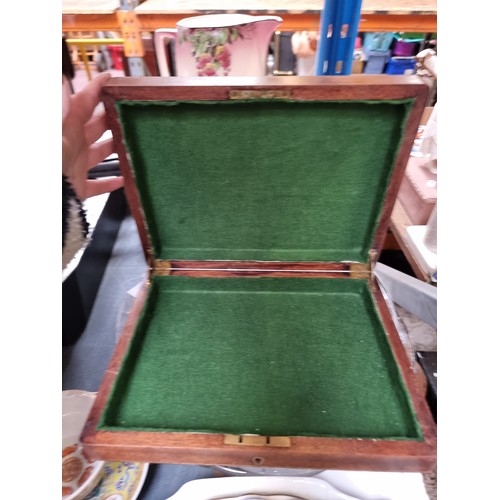 301 - An early 20th Century wooden games piece box with brass escutcheon to lid and green baize lining.