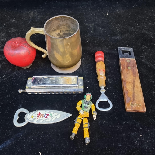 125 - A assortment of vintage items including bottle openers, a Chromatic harmonica and a brass Dublin mil... 