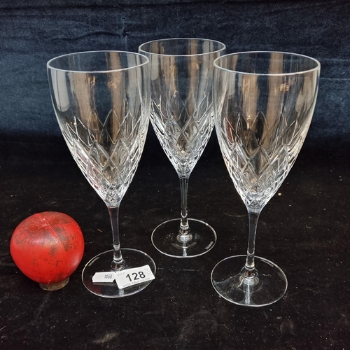 128 - Three tall Waterford crystal wine glasses. In very good condition with acid marks to base.