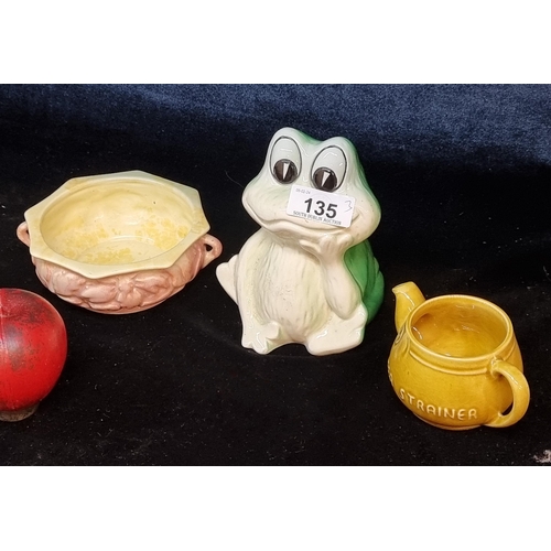 135 - Three vintage ceramic items including a Sylvac tea strainer and a sylvan frog money box.