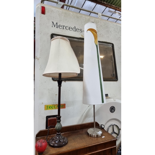 423 - Two stylish table lamps including a sleek chrome base example with a tall floral tubular shade and a... 