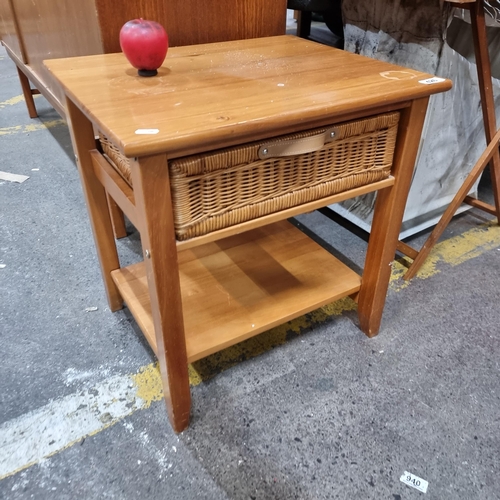 426 - A useful pine side table featuring a pull out whicker basket.