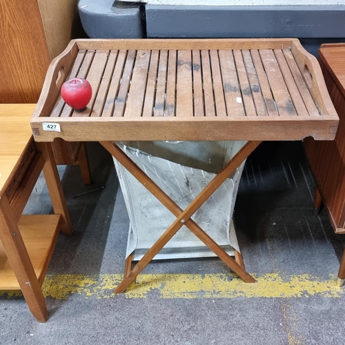 427 - A superb German made tray table with laundry basket beneath. Bottom folds.