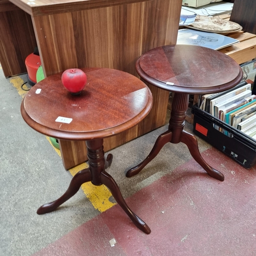 437 - A pair of round topped drinks side tables with tripod leg bases and turned pedestals.