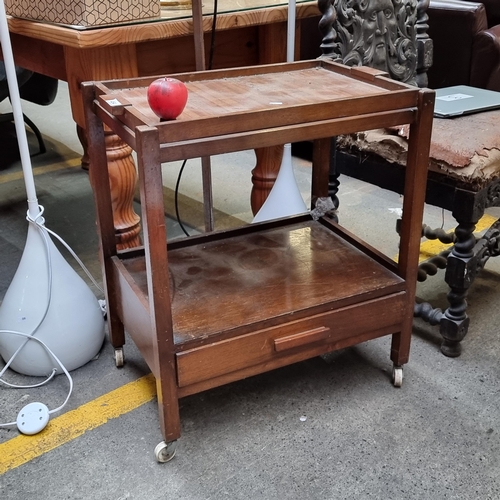 464 - A Mid Century hostess trolley with removable butlers tray to top and castors to feet.