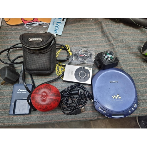 476 - A bag containing a mixed lot including Canon digital IXUS70 camera and battery chargers, a Sony Walk... 