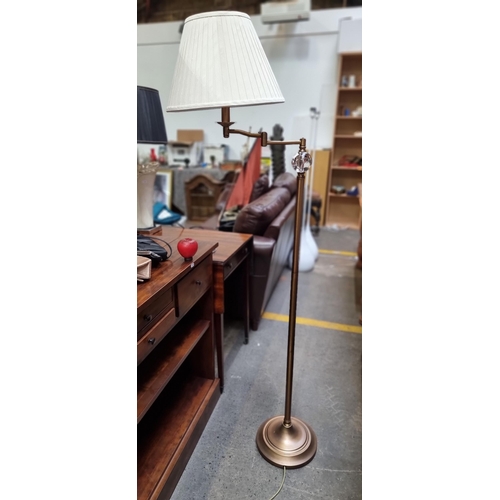 478 - An elegant floor standing lamp with a brushed bronze finish and glass ball element. Includes pleated... 