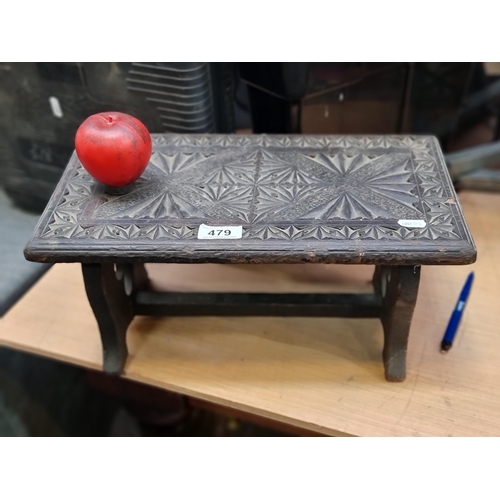 479 - A charming vintage ebonised carved wooden foot stool.